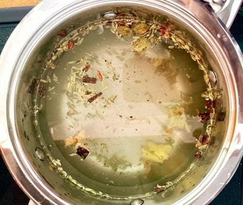 Spices tea with water in pot
